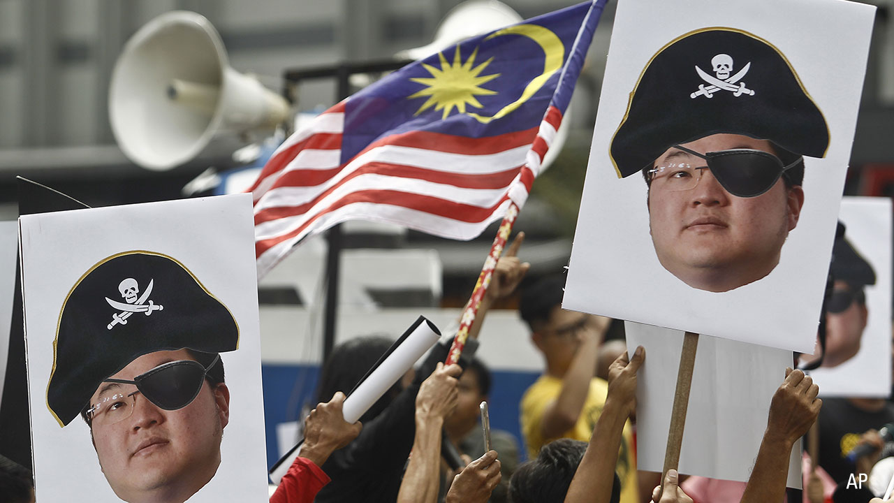 Protesters brandish effigies of fugitive Jho Low